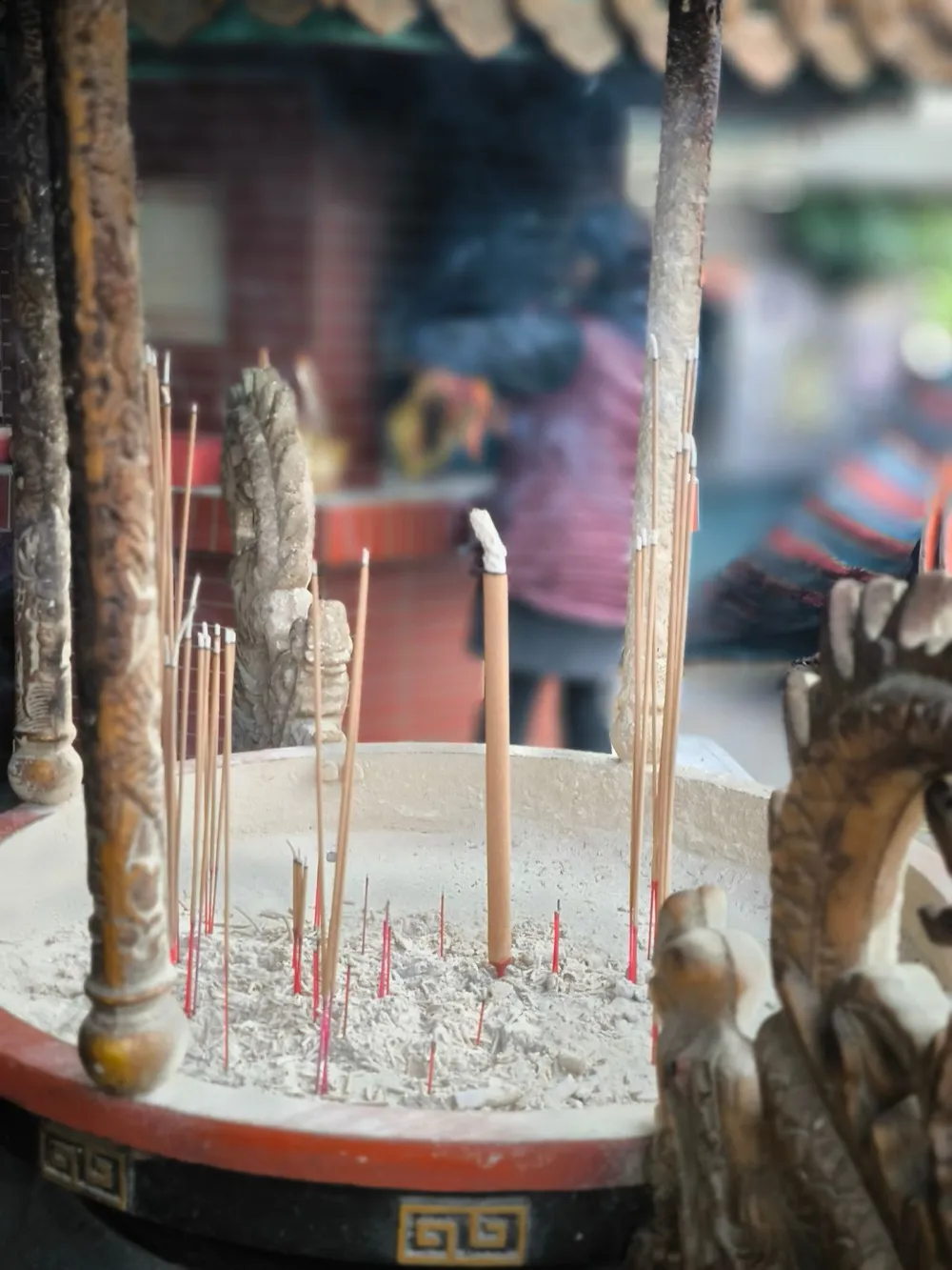 Incense sticks burning in a censer at a Chinese temple